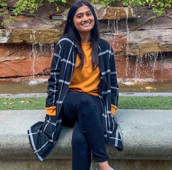 Photo of Drexel student Vaibhavi Bharadwaj sitting in front of a fountain.